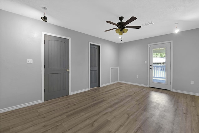 interior space featuring access to outside, hardwood / wood-style flooring, and ceiling fan