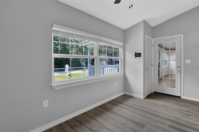 empty room featuring ceiling fan, hardwood / wood-style flooring, and lofted ceiling