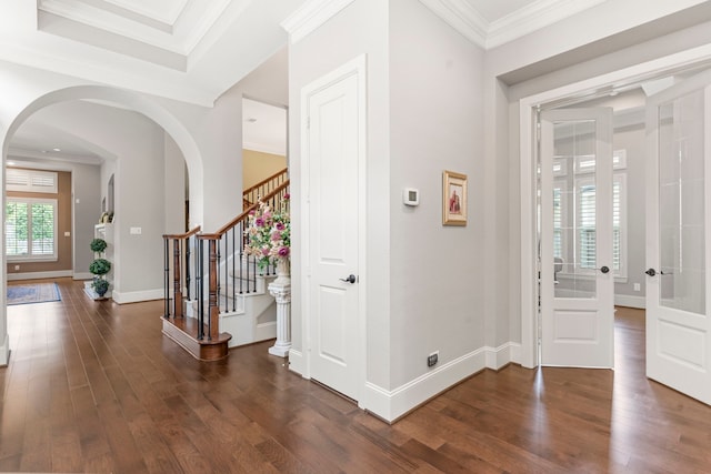 foyer featuring dark hardwood / wood-style flooring and crown molding