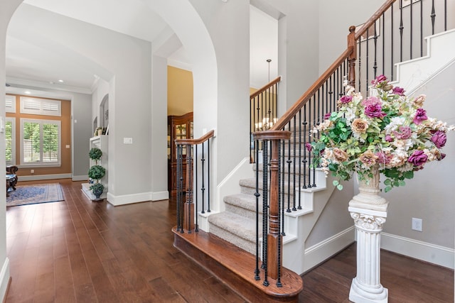 foyer with dark hardwood / wood-style floors and ornamental molding