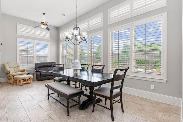 dining space with plenty of natural light and ceiling fan with notable chandelier