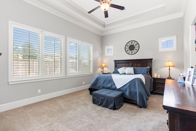 bedroom with light carpet, a raised ceiling, ceiling fan, and ornamental molding