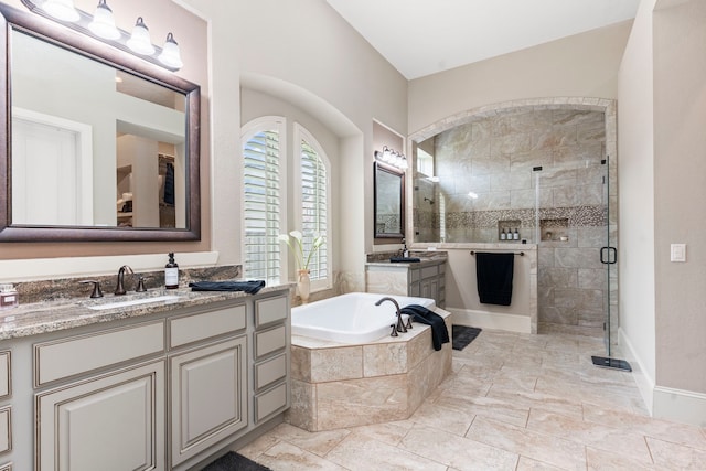 bathroom featuring vanity and shower with separate bathtub