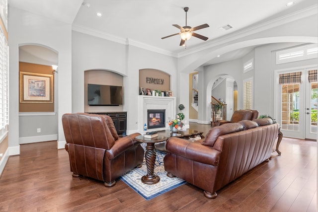 living room featuring crown molding, ceiling fan, and wood-type flooring