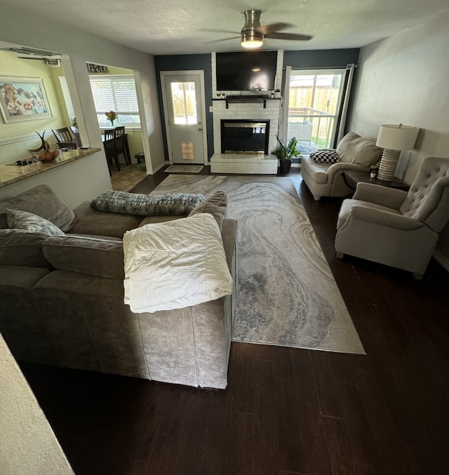 living room with ceiling fan, plenty of natural light, and hardwood / wood-style floors