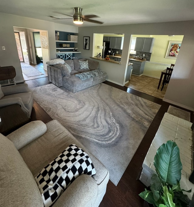 tiled living room featuring ceiling fan