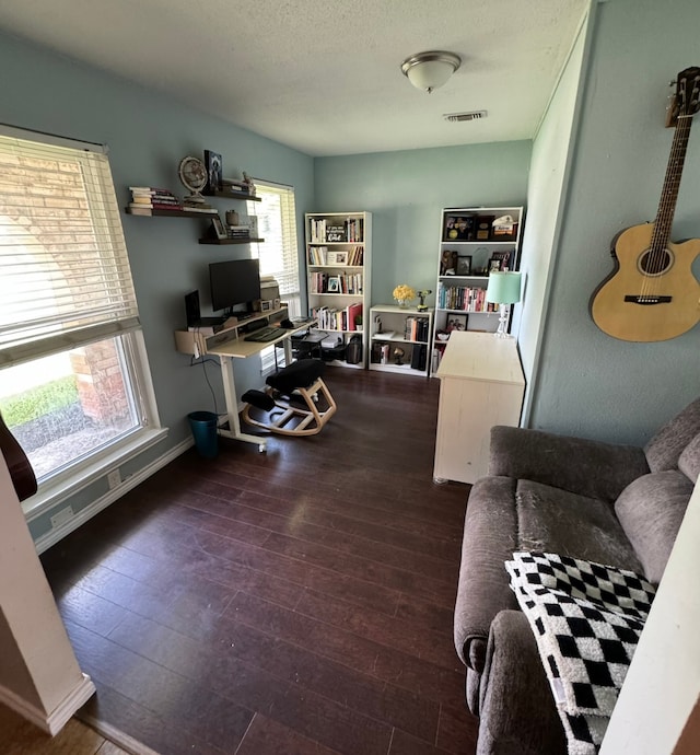 home office featuring wood-type flooring and a textured ceiling