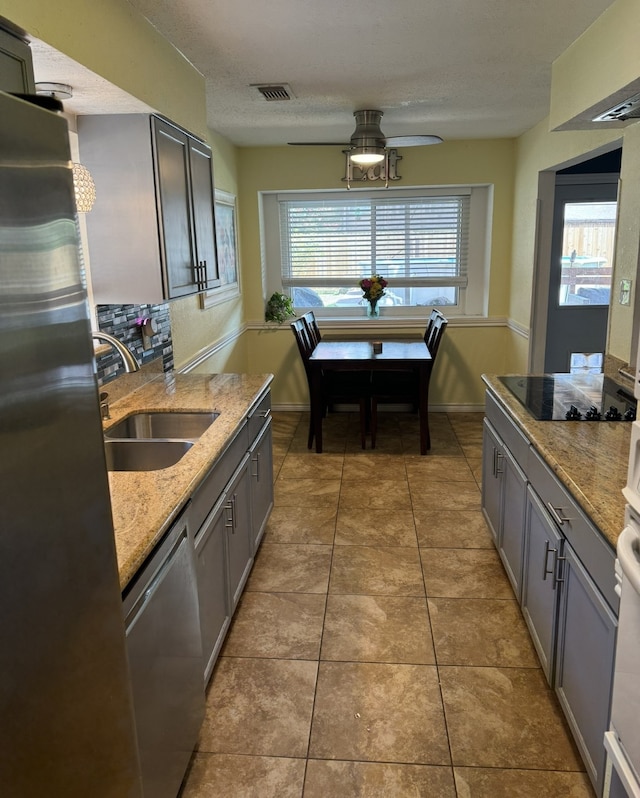 kitchen with ceiling fan, tile patterned floors, gray cabinetry, stainless steel appliances, and sink