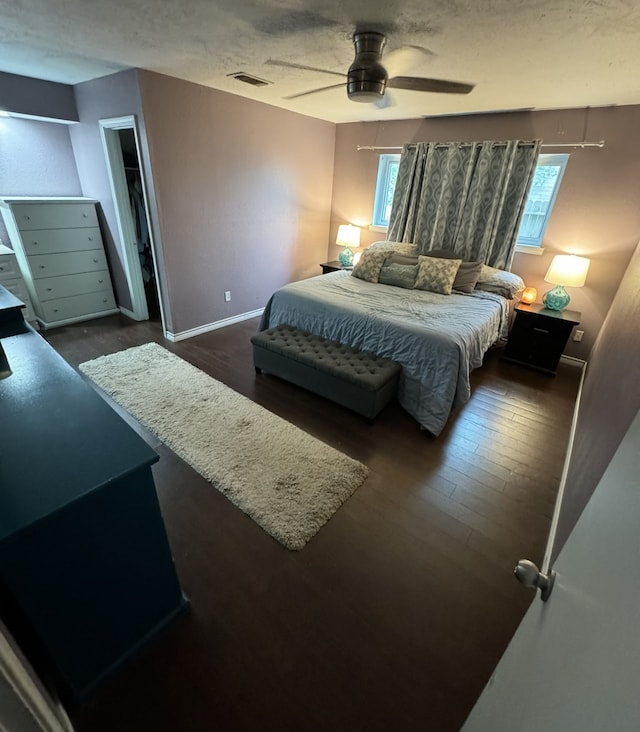 bedroom featuring ceiling fan and dark hardwood / wood-style flooring