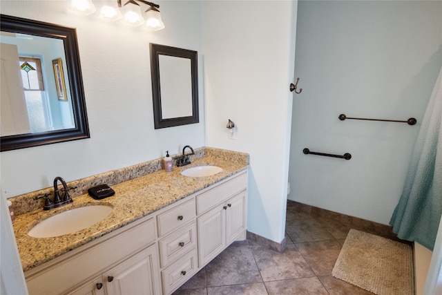 bathroom with double vanity and tile patterned flooring