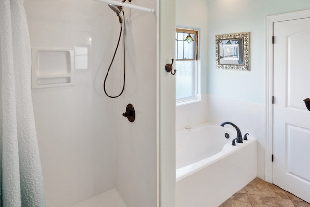 bathroom with tile patterned floors and a bathtub