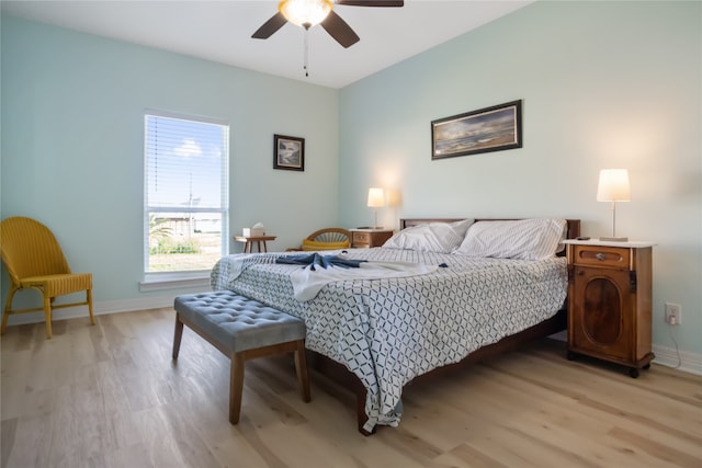 bedroom with ceiling fan and light hardwood / wood-style floors