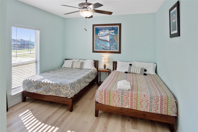 bedroom with ceiling fan and light hardwood / wood-style flooring