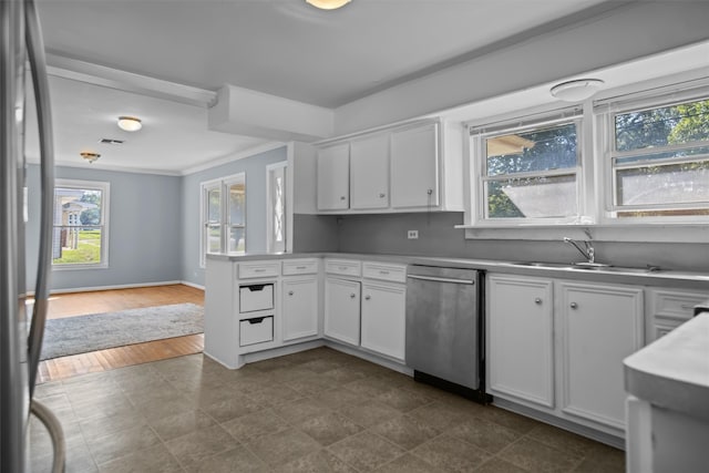 kitchen with dark tile patterned flooring, appliances with stainless steel finishes, and plenty of natural light