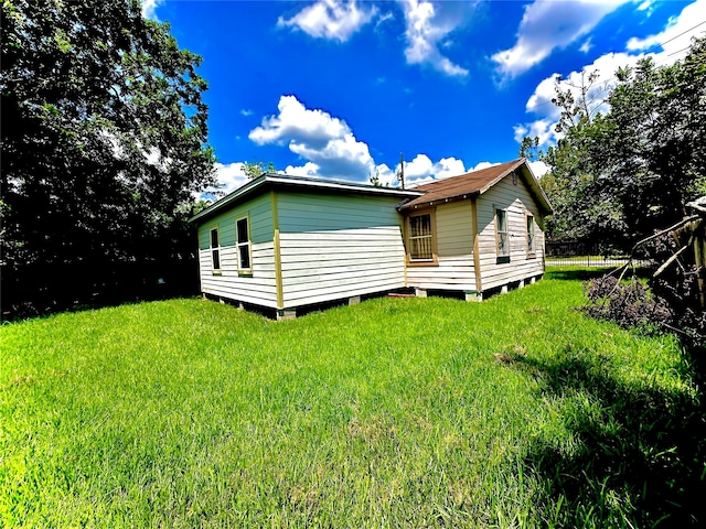 rear view of house featuring a lawn