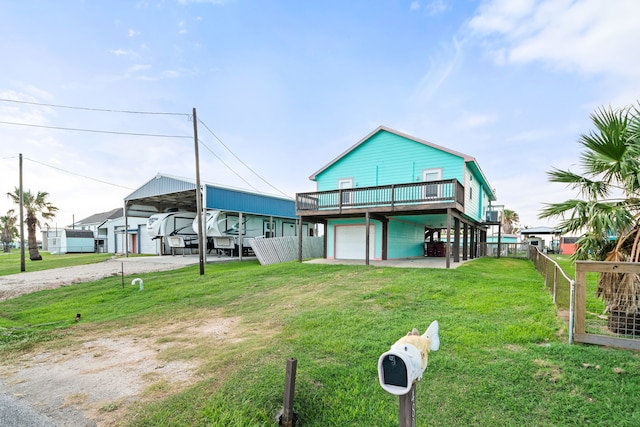 back of house featuring a carport, a yard, and a garage