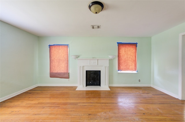 unfurnished living room featuring light hardwood / wood-style floors