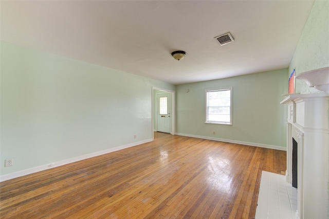 unfurnished living room featuring hardwood / wood-style flooring