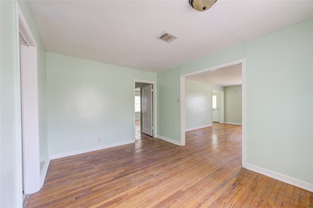 spare room with wood-type flooring