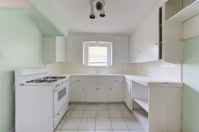 kitchen with sink, white cabinetry, white range with gas cooktop, and light tile patterned floors