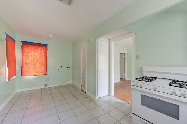 kitchen with white range with gas cooktop and light hardwood / wood-style floors