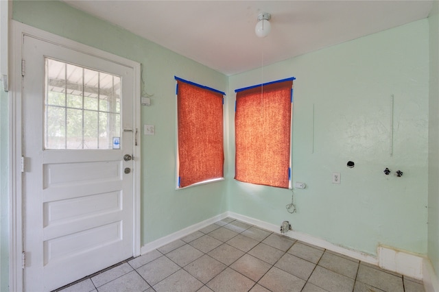 foyer entrance with light tile patterned flooring