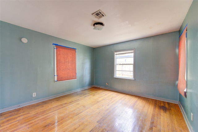 empty room with hardwood / wood-style flooring