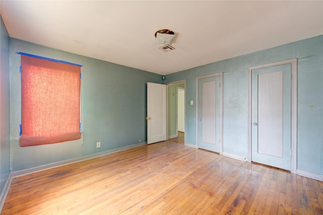 unfurnished bedroom with wood-type flooring