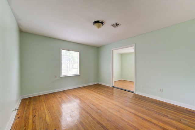 empty room with light hardwood / wood-style flooring