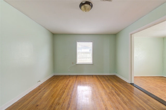 unfurnished room featuring hardwood / wood-style floors