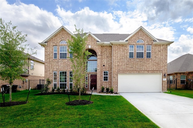 view of front of house featuring a front lawn and a garage