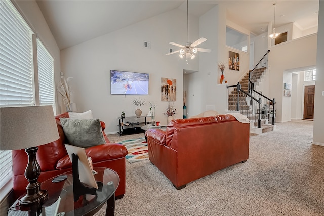 carpeted living room with a wealth of natural light, ceiling fan, and high vaulted ceiling