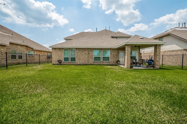 back of house with a lawn and a patio area