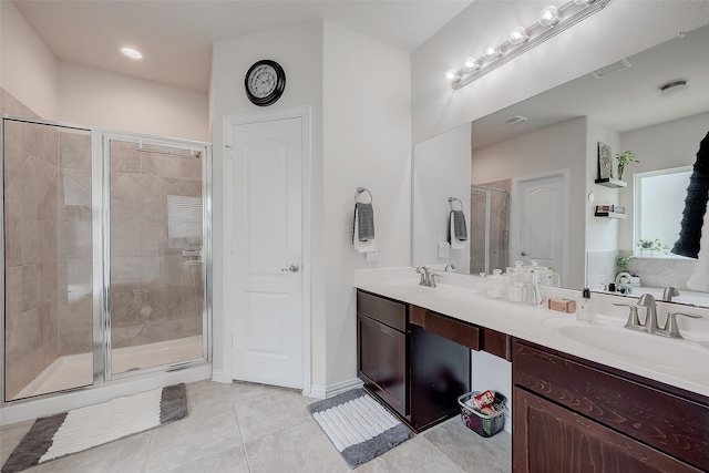 bathroom featuring vanity, tile patterned floors, and a shower with shower door