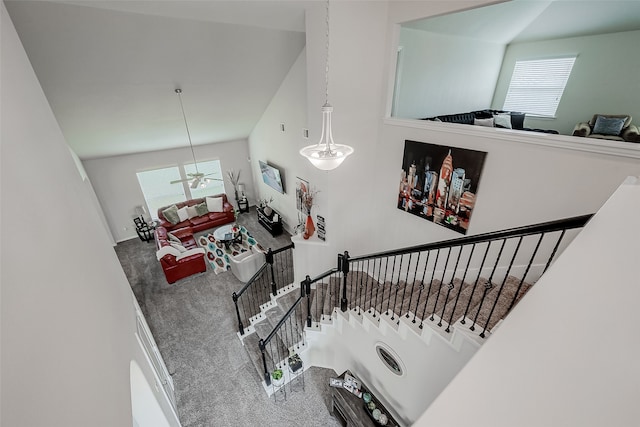 stairway with carpet floors, plenty of natural light, and a high ceiling