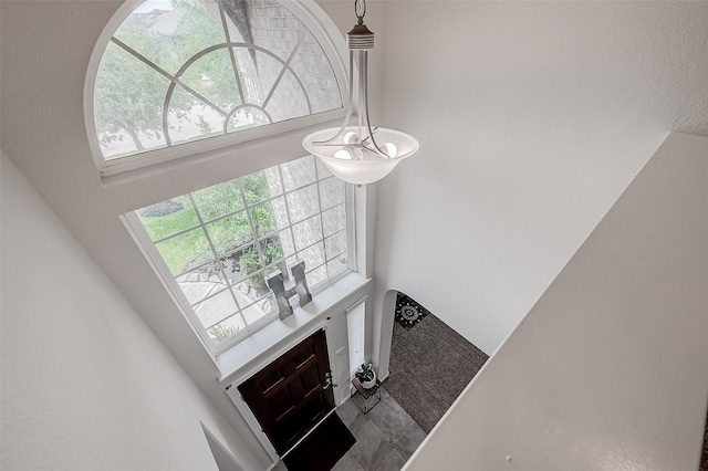 entrance foyer featuring a chandelier and a high ceiling