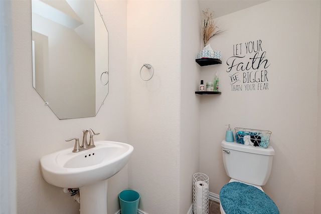 bathroom featuring sink and toilet