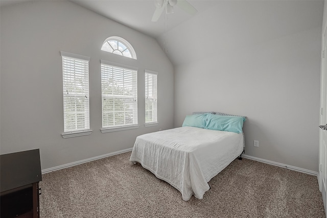 carpeted bedroom with ceiling fan and vaulted ceiling