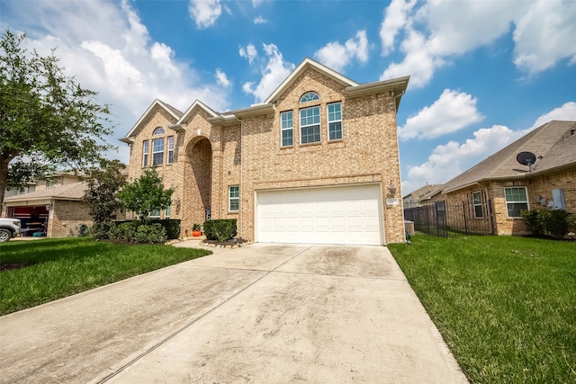 view of property featuring a garage and a front yard