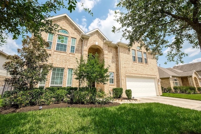 view of front of property featuring a garage and a front lawn