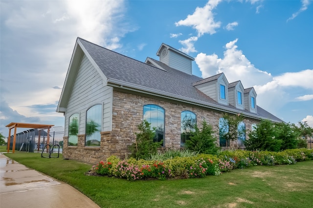 view of side of property with a yard and a carport