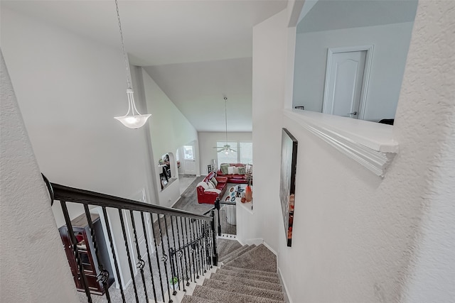 staircase with vaulted ceiling and carpet flooring