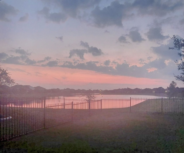 yard at dusk with a water and mountain view