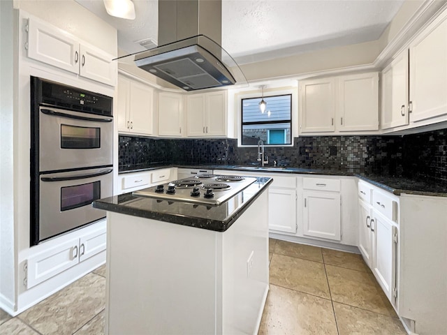 kitchen with sink, stainless steel appliances, island range hood, white cabinets, and a kitchen island