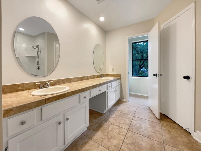 bathroom featuring walk in shower, tile patterned floors, and vanity