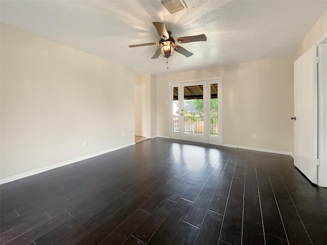 spare room featuring a textured ceiling, dark hardwood / wood-style floors, and ceiling fan