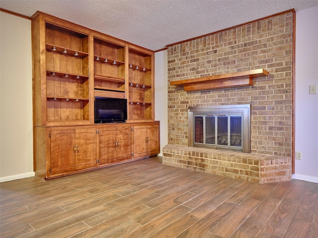 unfurnished living room featuring a textured ceiling and light wood-type flooring