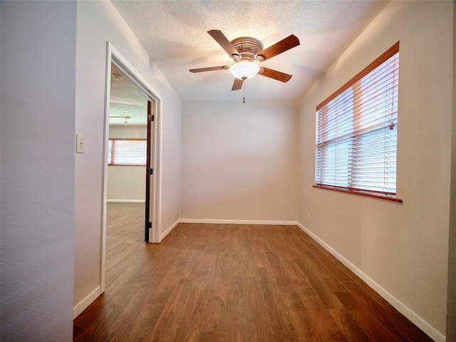 unfurnished room featuring hardwood / wood-style floors, a textured ceiling, and ceiling fan