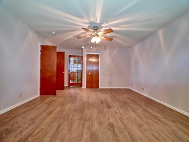 spare room with hardwood / wood-style flooring and ceiling fan