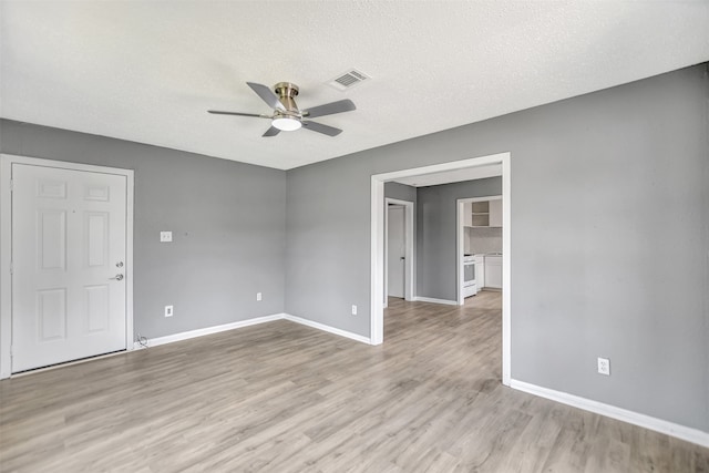 spare room featuring ceiling fan, wood-type flooring, and a textured ceiling